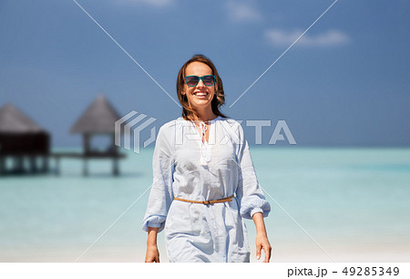 happy woman over tropical beach and bungalow happy woman over tropical beach and bungalow 49285349