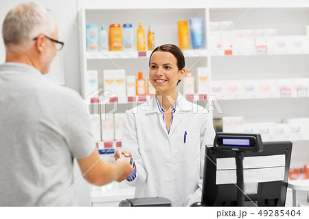 apothecary taking customer credit card at pharmacy apothecary taking customer credit card at pharmacy 49285404
