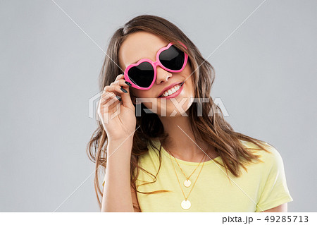 teenage girl in heart-shaped sunglasses teenage girl in heart-shaped sunglasses 49285713
