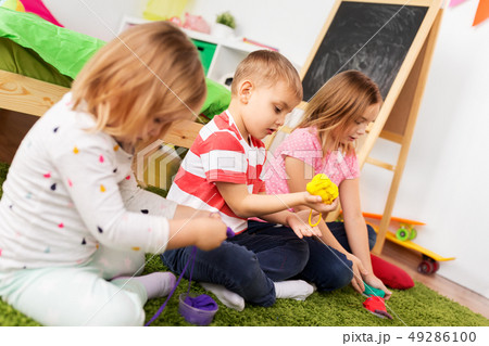 children with modelling clay or slimes at home 49286100