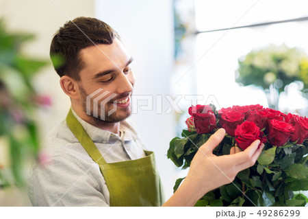 florist or seller setting red roses at flower shop 49286299