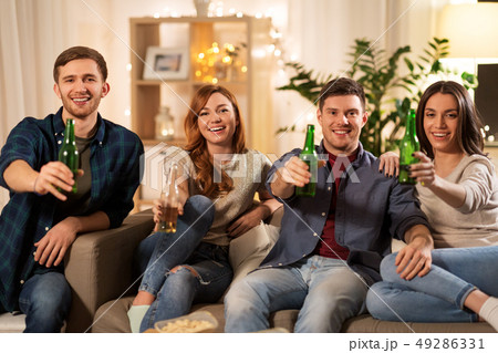 friends toasting non-alcoholic beer at home 49286331