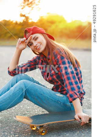 Cheerful girl in a shirt and a baseball cap  49291625