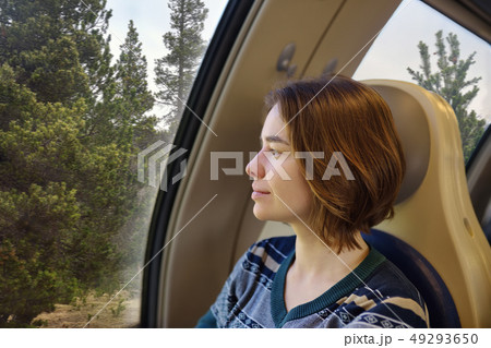 Portrait of a beautiful pensive girl in train Portrait of a beautiful pensive girl in train 49293650