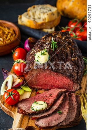 Fresh grilled meat. Grilled beef steak medium rare on wooden cutting board. Fresh grilled meat. Grilled beef steak medium rare on wooden cutting board. 49295751
