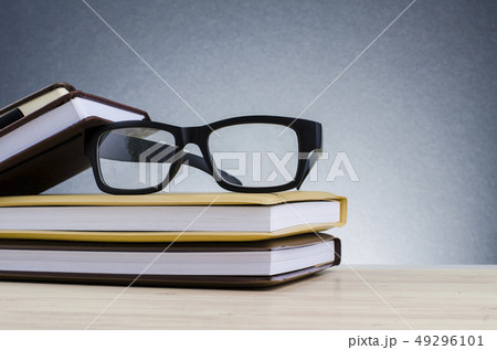 Education concept, spectacles on stack of books  49296101