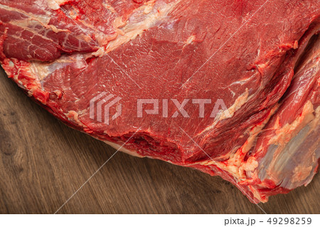 Raw fresh beef on a wooden background, catalog. 49298259