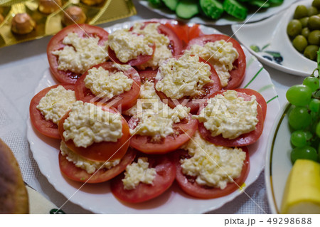 A dish of tomato with cheese and garlic on a white 49298688