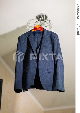 stylish black suit with white shirt and bow tie on 49299057