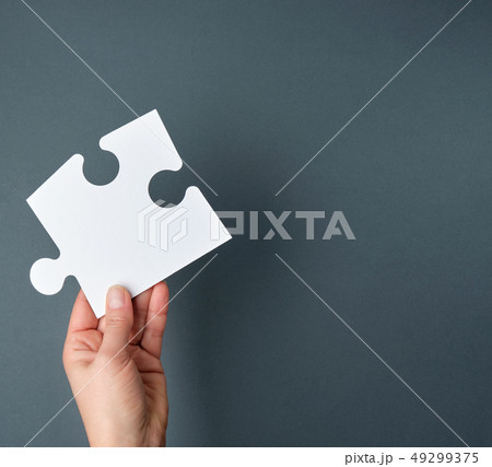 white big puzzle in female hand white big puzzle in female hand 49299375
