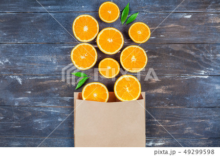 Fresh oranges on dark wooden background Fresh oranges on dark wooden background 49299598