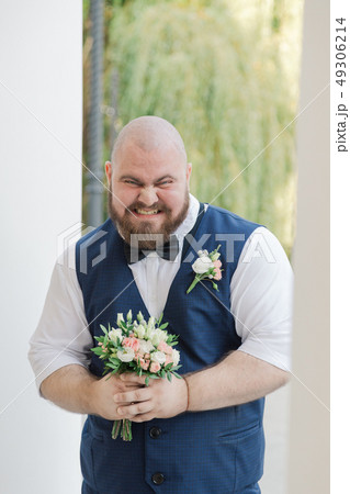 Stylish bearded fat groom with wedding bouquet in Stylish bearded fat groom with wedding bouquet in 49306214
