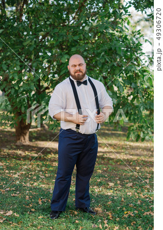 Stylish bearded fat groom in the park. Stylish bearded fat groom in the park. 49306720
