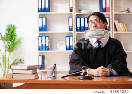 Young handsome judge working in court Young handsome judge working in court 49307039