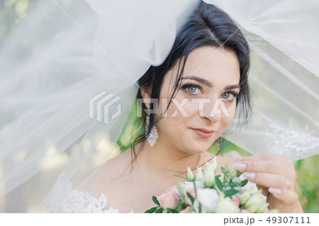 Very beautiful bride is holding a bouquet. Very beautiful bride is holding a bouquet. 49307111