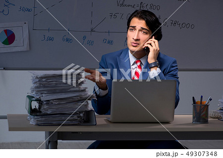 Young elegant financial specialist working in the office night t Young elegant financial specialist working in the office night t 49307348