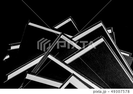 Books piled on top of each other, black and white Books piled on top of each other, black and white 49307578