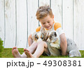 Little boy and corgi puppies 49308381