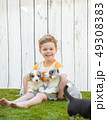 Little boy and corgi puppies 49308383