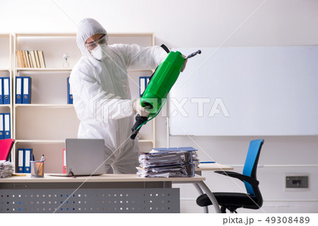 Professional contractor doing pest control at office  49308489