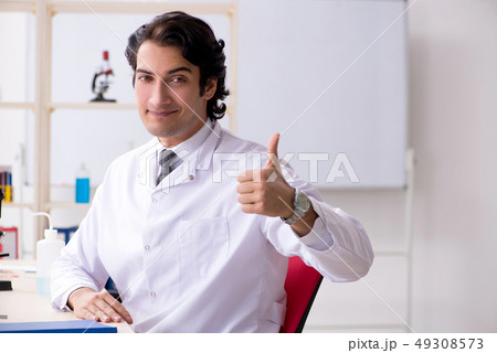Young handsome chemist working in the lab Young handsome chemist working in the lab 49308573