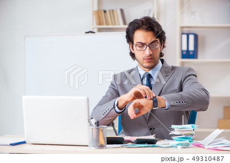 Young handsome businessman in budget planning concept  49310487