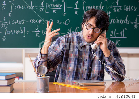 Funny male math teacher in the classroom  49310641