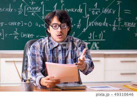 Funny male math teacher in the classroom  49310646