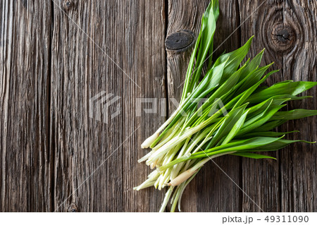 Fresh wild garlic leaves on a wooden background 49311090