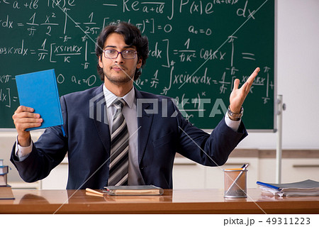 Young male math teacher in classroom Young male math teacher in classroom 49311223