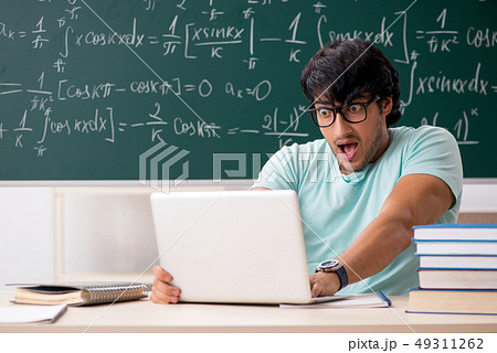 Young male student mathematician in front of chalkboard Young male student mathematician in front of chalkboard 49311262