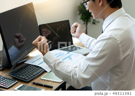 young businessman sit and look to the computer 49311391