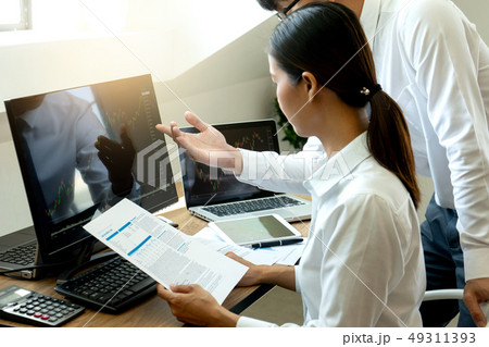 business man and woman sit at ther table 49311393