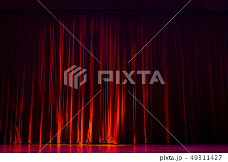 Red curtains with the lights of the show and the 49311427