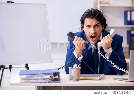 Young handsome businessman working in the office 49313640