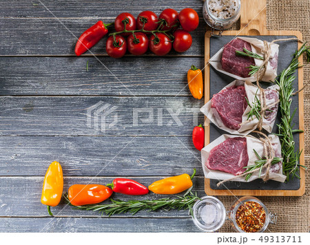 Raw meat steaks and vegetables. Fresh meat 49313711