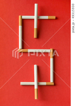 Dollar sign laid out of cigarettes. Dollar sign laid out of cigarettes. 49315930
