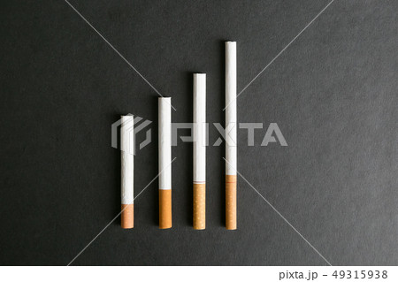Cigarettes lie on a black background. Cigarettes lie on a black background. 49315938