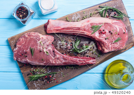 Raw beef tomahawk steak Raw beef tomahawk steak 49320240