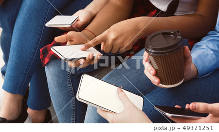 Girl pointing finger on phone screen, showing new app Girl pointing finger on phone screen, showing new app 49321251