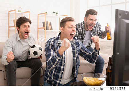 Goal. Very excited friends watching football match Goal. Very excited friends watching football match 49321573
