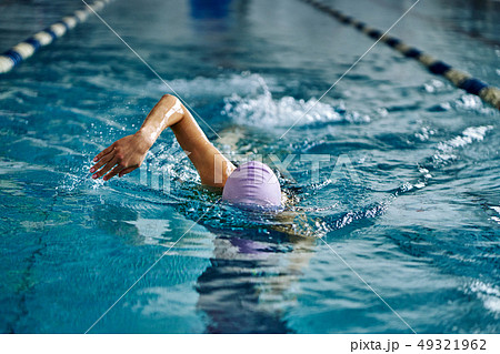 Female athlete swimming fast in crawl style.  49321962
