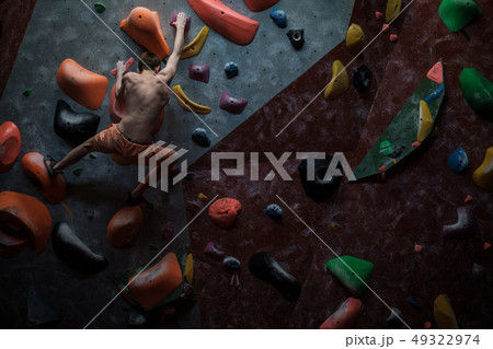 Athletic man practicing in a bouldering gym 49322974