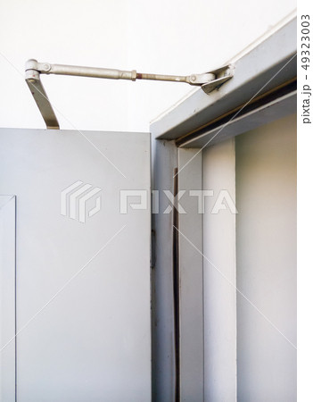 Slim door closer on the metal door. Slim door closer on the metal door. 49323003