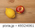 Lemon and apple on a wooden background. 49324061