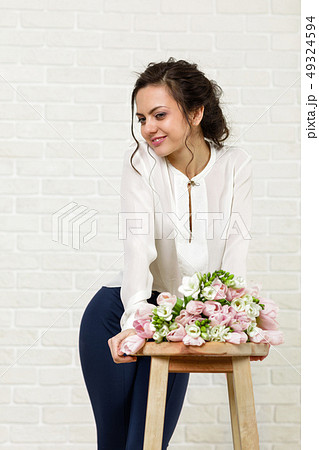 beautiful brunette woman with a bouquet of tulips flowers beautiful brunette woman with a bouquet of tulips flowers 49324594