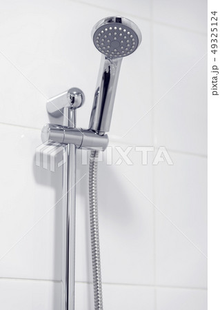 Shower chrome head in bathroom, white candid interior Shower chrome head in bathroom, white candid interior 49325124