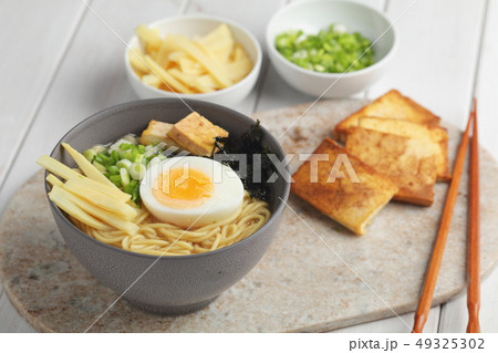 Egg noodle soup with bamboo shoots, tofu, and nori 49325302