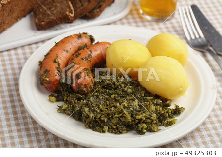Roasted sausages, kale, and potato 49325303