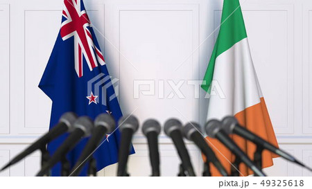Flags of New Zealand and Ireland at international meeting or negotiations press conference. 3D 49325618